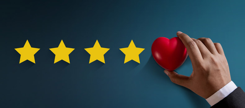 A hand placing a heart next to 4 stars